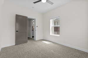 Empty room featuring ceiling fan and light colored carpet