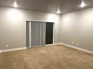 Unfurnished room with carpet flooring and baseboards