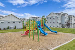 Community playground featuring a residential view and a yard