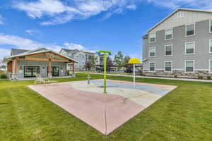 View of sport court with a yard