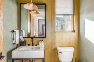 Half bathroom featuring toilet and a sink