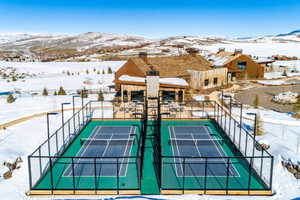 View of tennis court with a mountain view