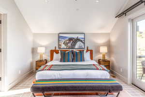 Bedroom with lofted ceiling, carpet flooring, and access to exterior