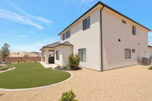 Back of house with a patio area and stucco siding