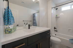 Full bathroom featuring vanity and shower / bath combination with curtain
