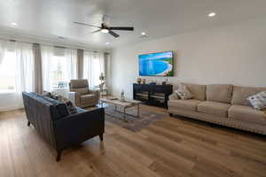 Living area featuring a ceiling fan, wood finished floors, and recessed lighting