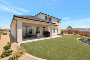 Back of house featuring a fenced backyard, a patio, stucco siding, and a tile roof