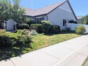 View of side of home with roof with shingles