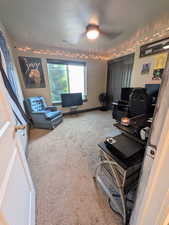 Carpeted bedroom with ceiling fan