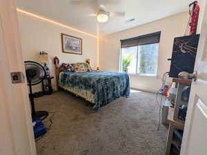 Carpeted bedroom with ceiling fan