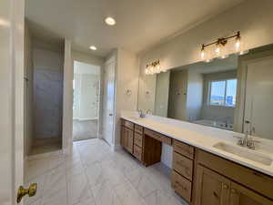 Full bath featuring a garden tub, double vanity, light marble finish flooring, recessed lighting, and a walk in shower