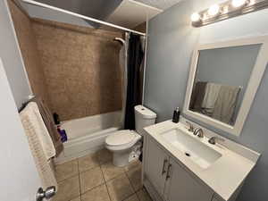 Bathroom with vanity, tile patterned flooring, and shower / bath combo with shower curtain