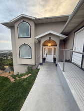 View of exterior entry featuring stucco siding