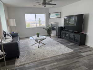 Living room with a ceiling fan and wood finished floors