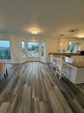 Dining room featuring dark wood finished floors and baseboards
