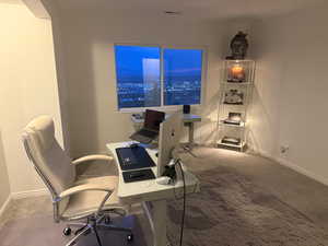 Home office featuring carpet and baseboards