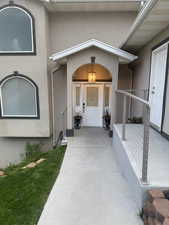 Entrance to property with stucco siding