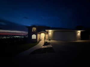 View of front of house with concrete driveway, a garage, and stucco siding