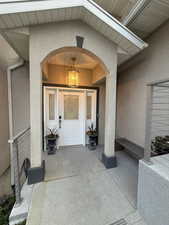 Doorway to property featuring stucco siding