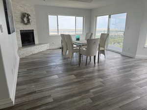 Dining area featuring a fireplace and dark wood-style floors