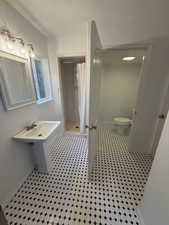 Bathroom featuring a shower stall and tile patterned floors