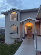 Doorway to property with stucco siding and a yard