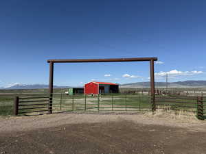 View of yard with a pole building, a rural view, an outbuilding, a mountain view, and a garage