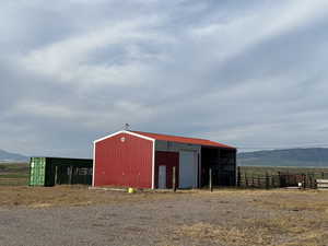 View of pole building with a mountain view