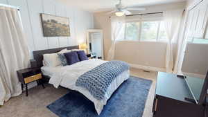 Bedroom featuring multiple windows, carpet, and ceiling fan