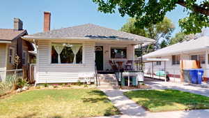 Bungalow with roof with shingles and a porch