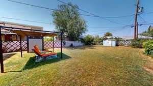 View of yard featuring a storage unit
