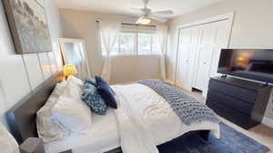 Bedroom with carpet, a closet, and a ceiling fan