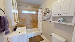 Bathroom featuring shower / bath combo with shower curtain and vanity