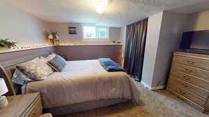 Bedroom featuring carpet flooring and baseboards