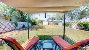 Fenced backyard featuring a storage shed