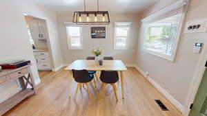 Dining room featuring light wood finished floors and baseboards