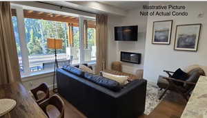 Living area with healthy amount of natural light and wood finished floors