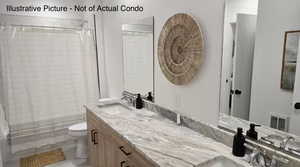 Full bathroom featuring double vanity and curtained shower