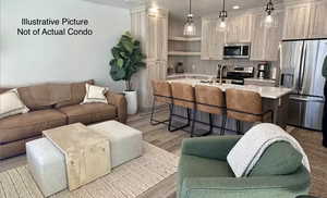 Living room with light wood-style floors and recessed lighting