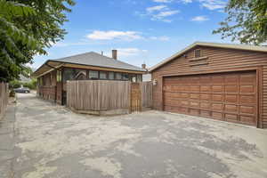 View of detached 2 car garage/ driveway