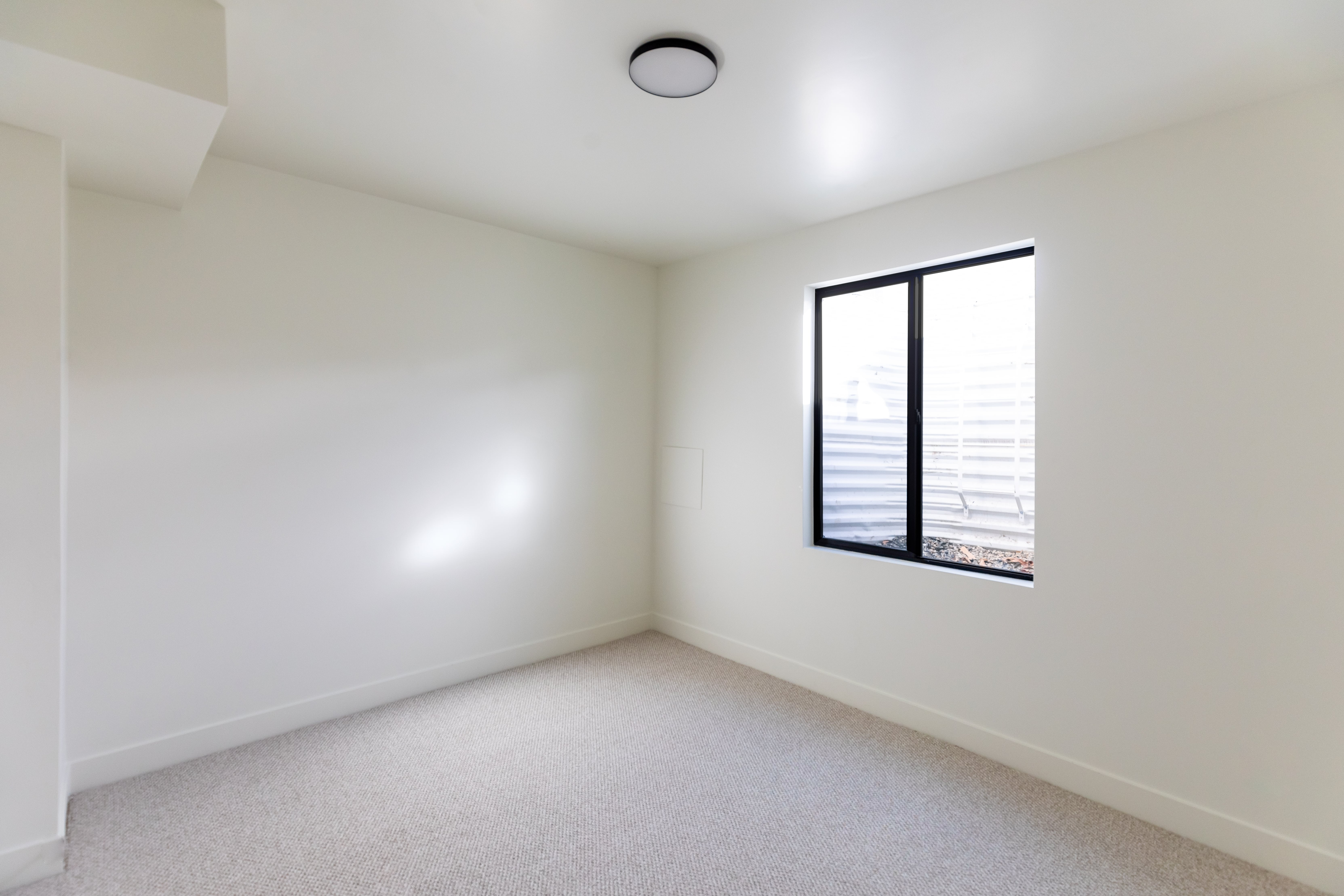 Empty room featuring carpet flooring and baseboards