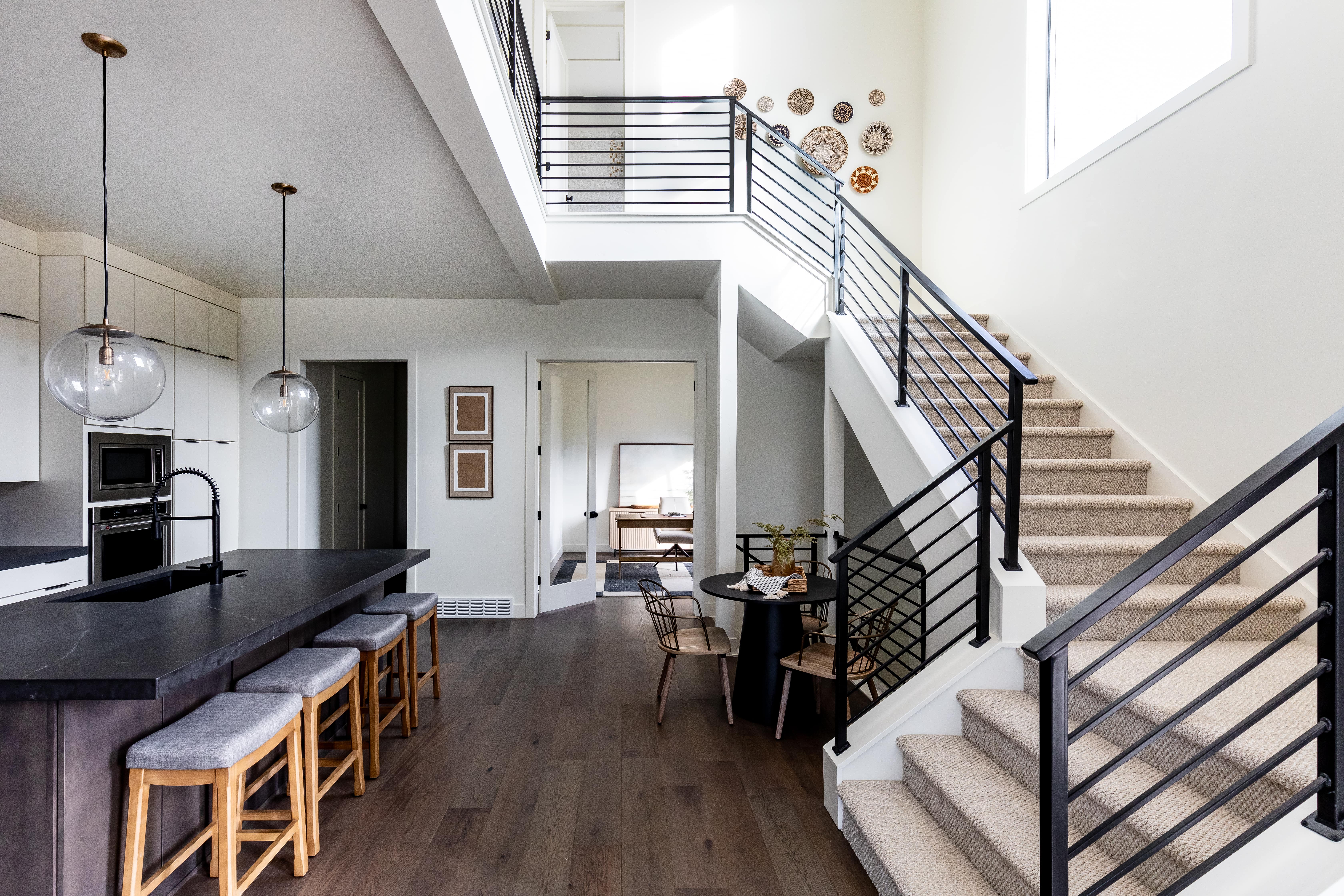 Stairs featuring wood finished floors and a high ceiling