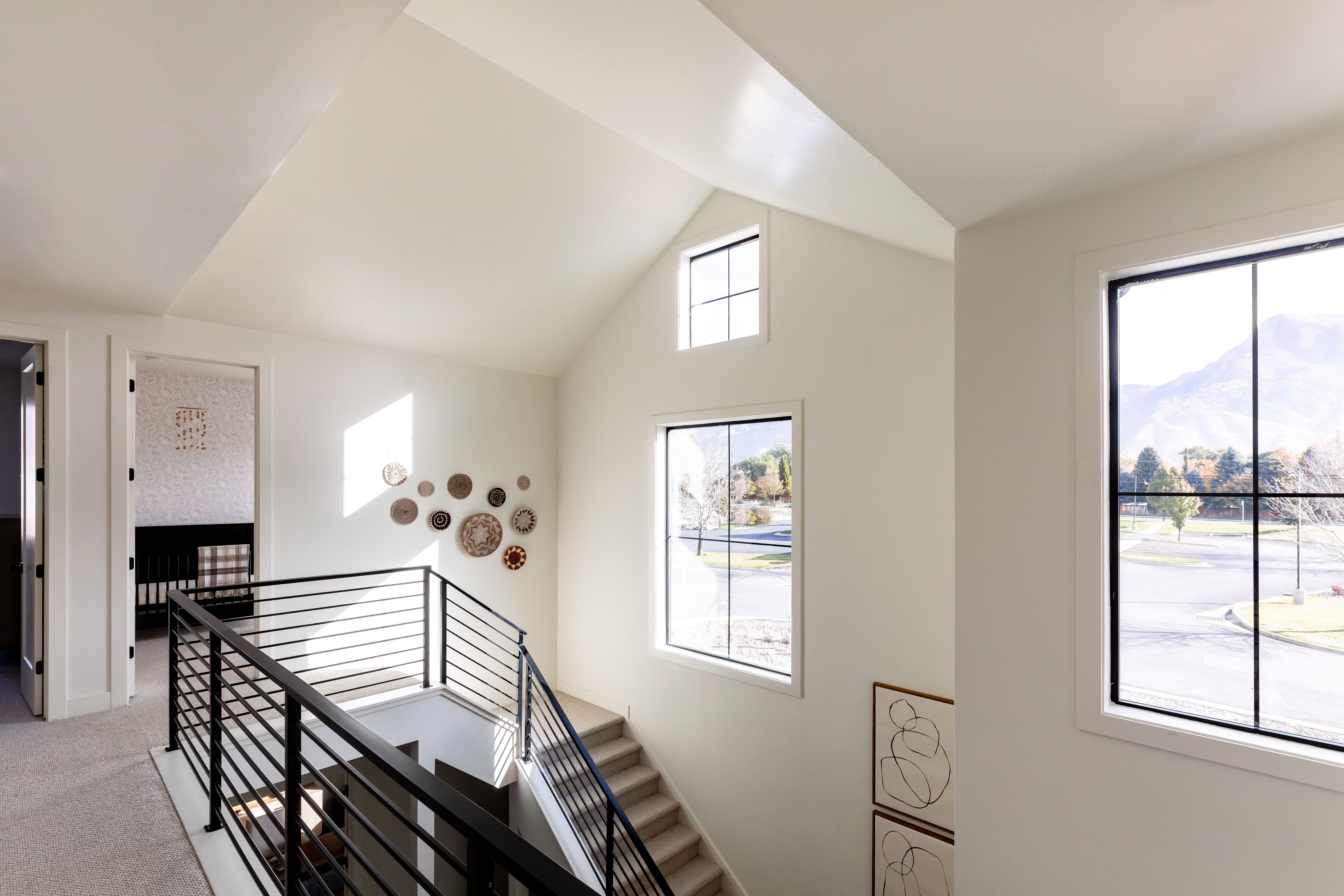 Staircase featuring vaulted ceiling and carpet flooring