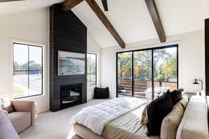 Bedroom with access to outside, carpet floors, beamed ceiling, a large fireplace, and high vaulted ceiling