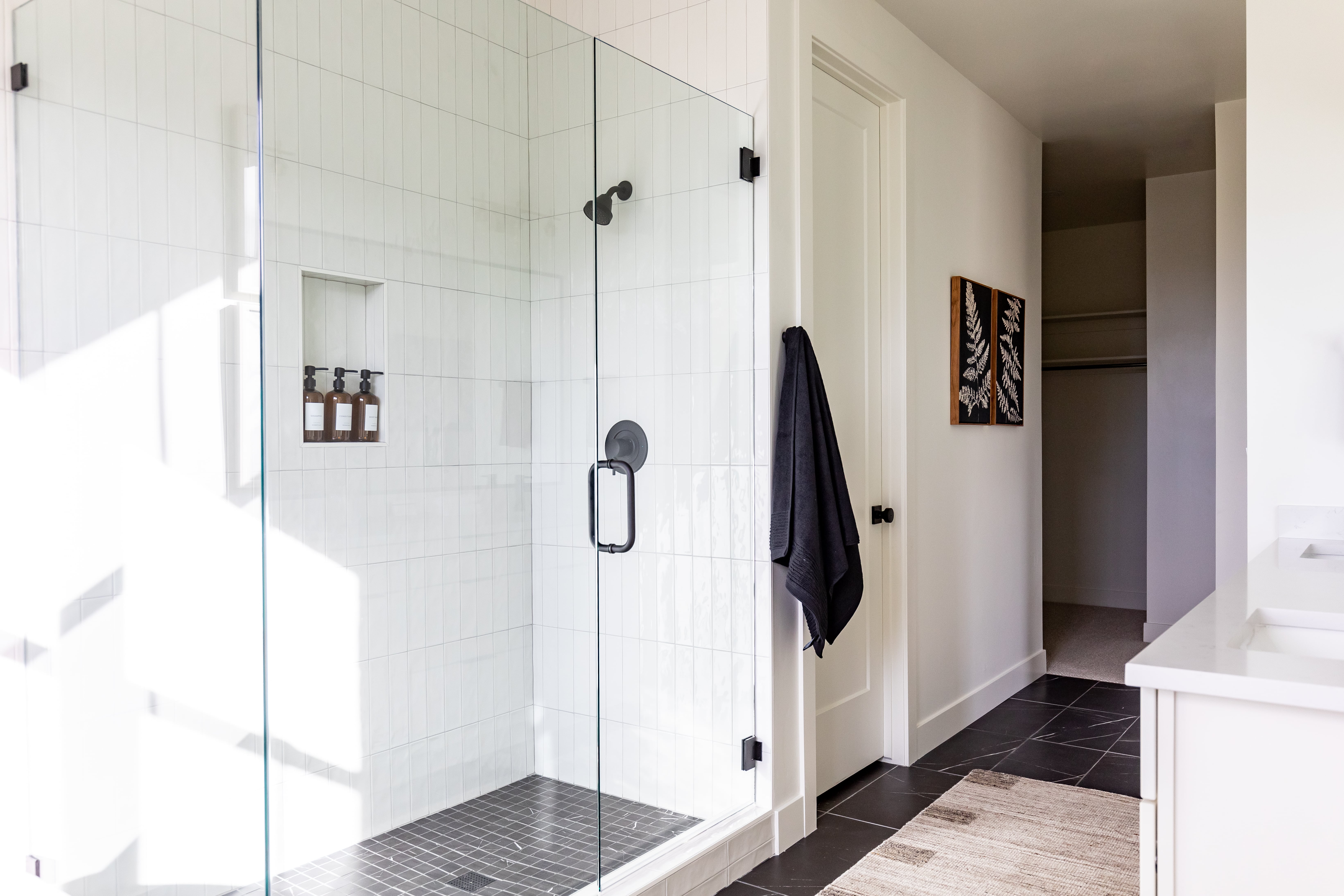 Full bath with vanity, a shower stall, and tile patterned flooring