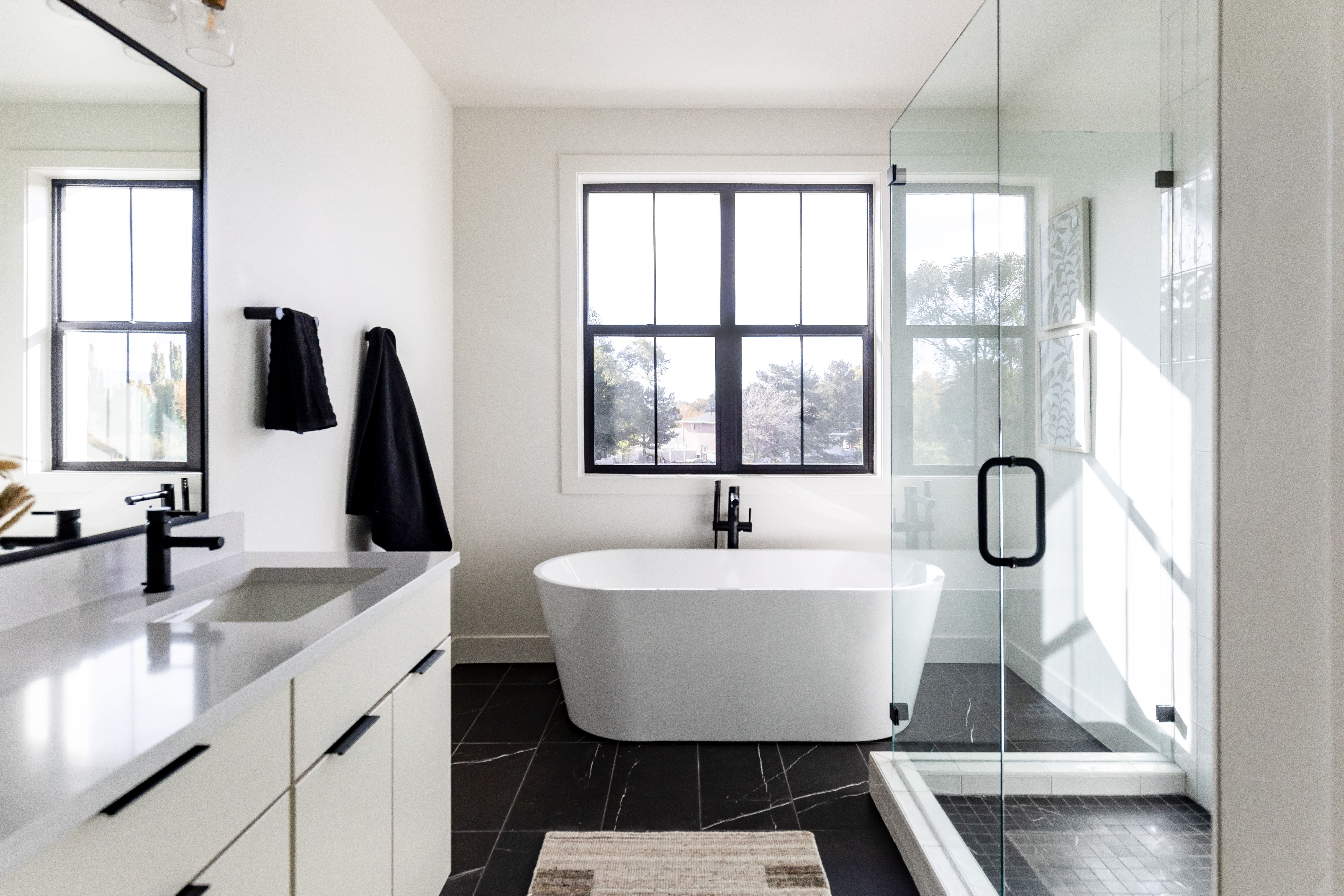 Full bath featuring vanity, a freestanding bath, and a stall shower