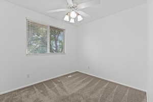 Unfurnished room with carpet flooring and a ceiling fan