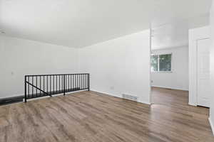 Empty room featuring wood finished floors and baseboards