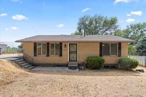 Ranch-style house with entry steps, brick siding, and roof with shingles