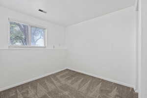Unfurnished room with carpet floors and baseboards